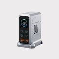 Exacable 240W multi-port USB charger station with a sleek silver and black design, featuring a digital display screen and multiple charging ports, set against a clean light gray background.
