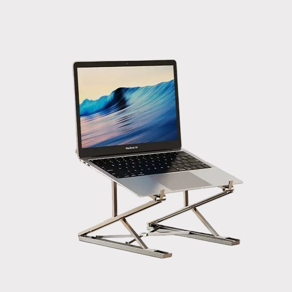 A silver Exacable laptop stand holding a silver laptop on a clean white background, with the Exacable brand logo printed in the top-left corner.