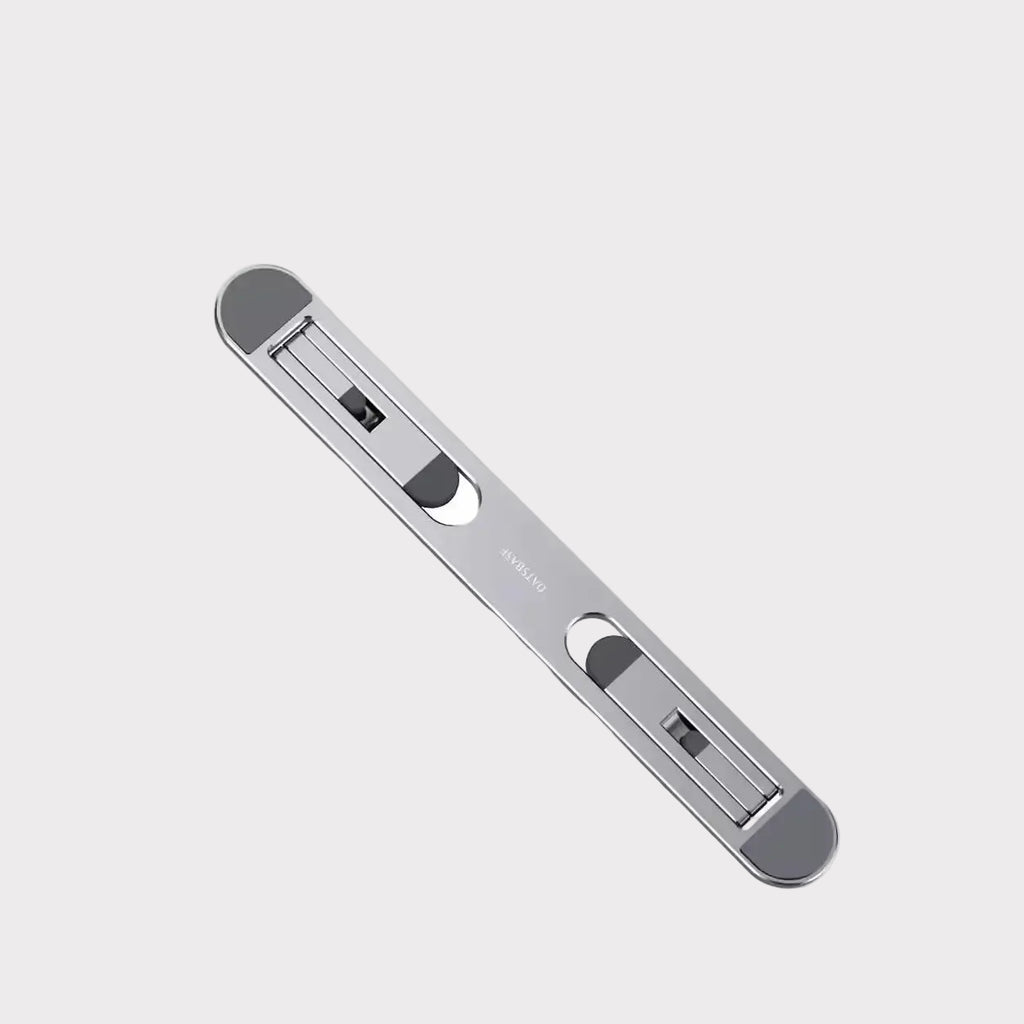 A sleek, metallic silver cable protector with rounded ends and two built-in cable sleeves, shown diagonally on a light gray background with the brand name 'EXACABLE' in the top-left corner.