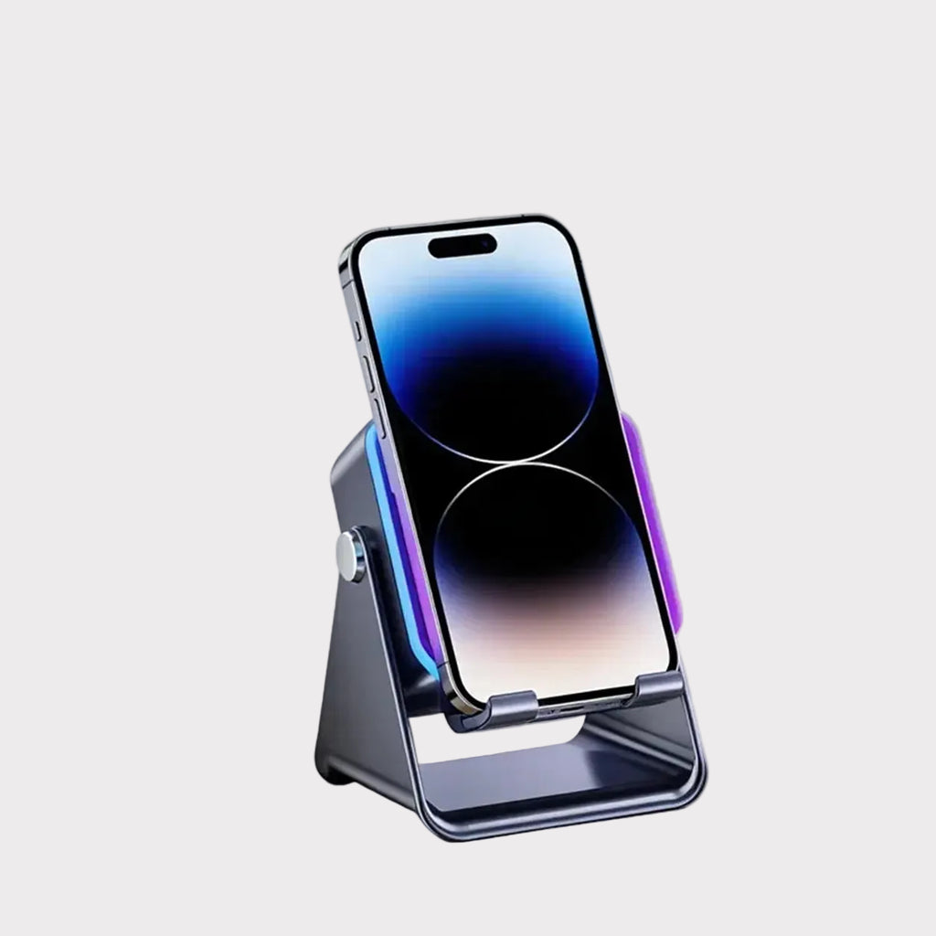 A metallic dark gray phone stand holding a smartphone, shown on a clean light gray background with the brand name EXACABLE in the top-left corner.